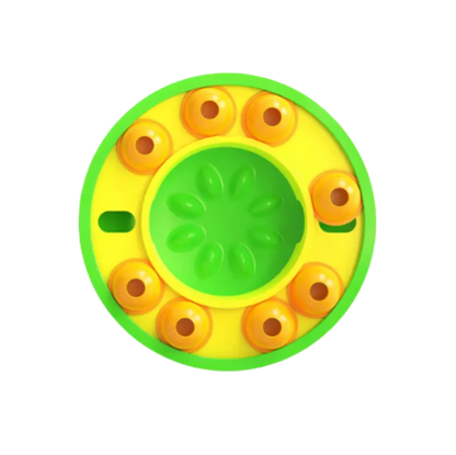 Round yellow and green dog slow puzzle feeder with a central circular design on a white background